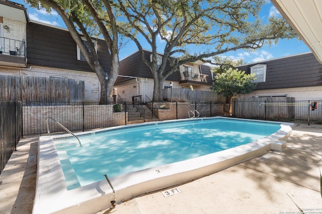 community pool featuring fence