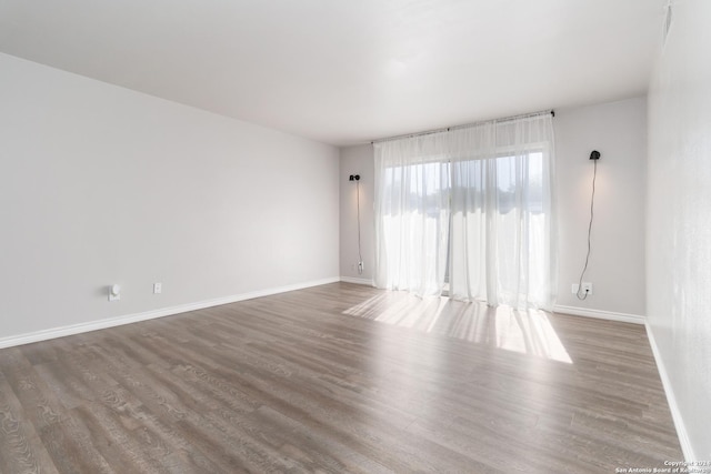 8038 Broadway Unit 225L, San Antonio, TX 78209 - empty room featuring wood finished floors and baseboards