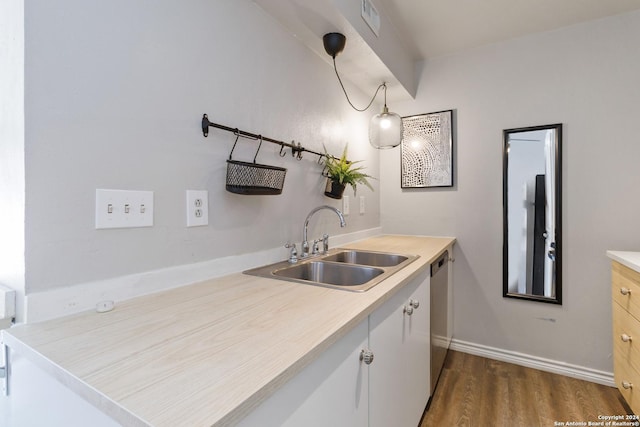 8038 Broadway Unit 225L, San Antonio, TX 78209 - kitchen with dark wood-style flooring, a sink, baseboards, light countertops, and dishwasher