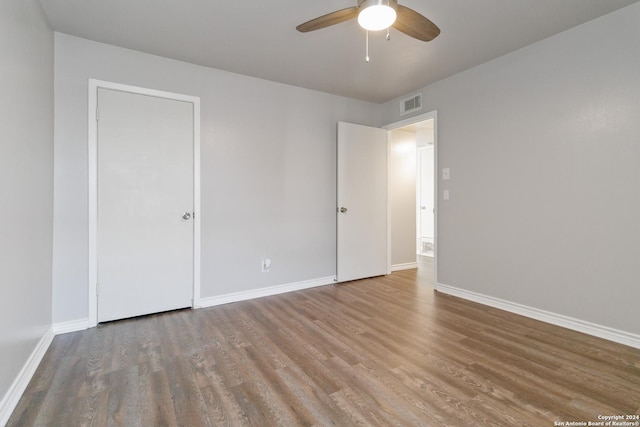 8038 Broadway Unit 225L, San Antonio, TX 78209 - unfurnished bedroom with ceiling fan, wood finished floors, visible vents, and baseboards