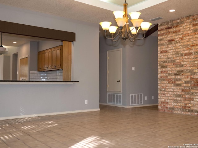 interior space featuring a textured ceiling and a chandelier