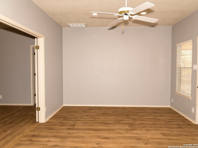 spare room featuring hardwood / wood-style floors, a textured ceiling, and ceiling fan