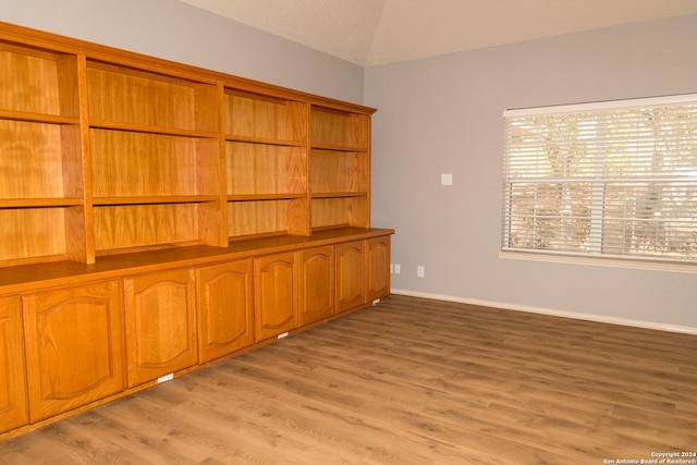 interior space with lofted ceiling and light wood-type flooring