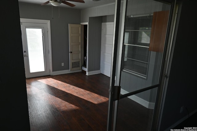 interior space with dark hardwood / wood-style floors, ceiling fan, and a healthy amount of sunlight