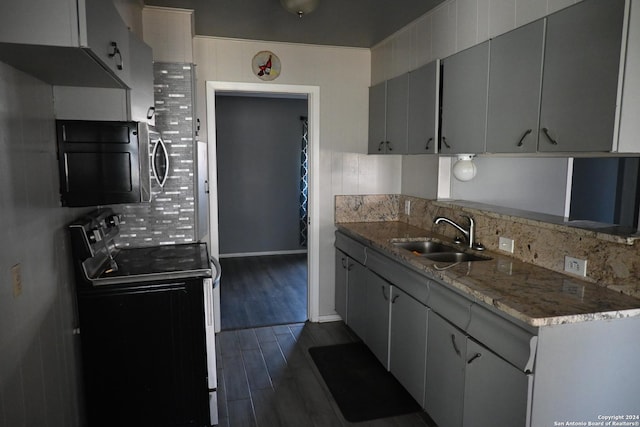 kitchen featuring dark hardwood / wood-style flooring, light stone countertops, sink, and black electric range oven