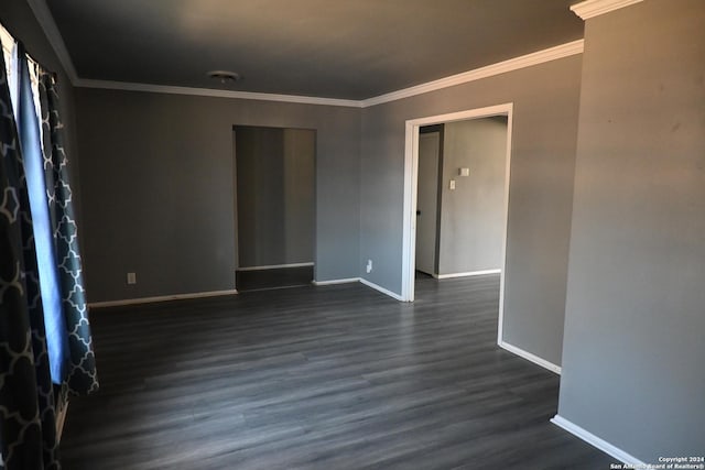 unfurnished room featuring crown molding and dark hardwood / wood-style flooring