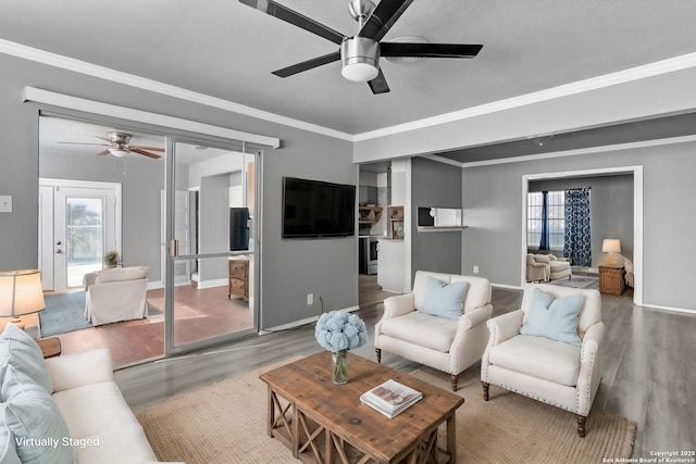 living room featuring crown molding, hardwood / wood-style floors, and ceiling fan