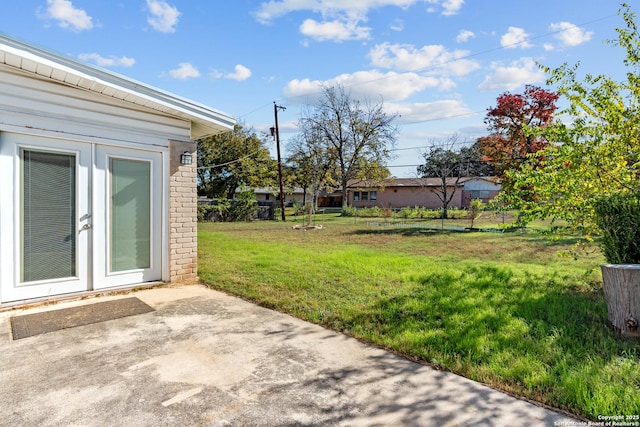 view of yard featuring french doors and a patio area