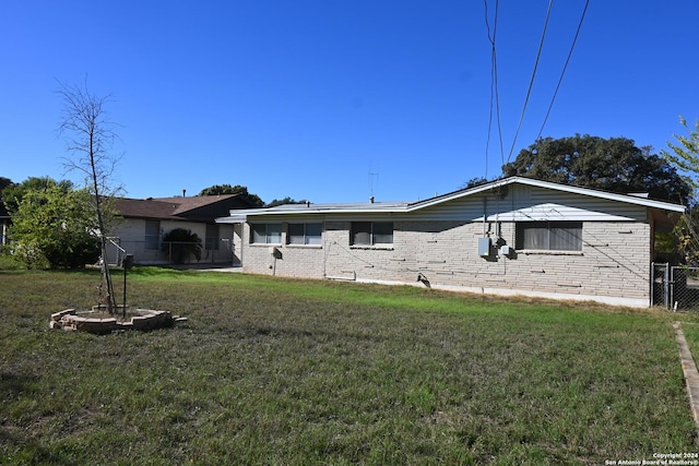 rear view of property featuring a yard