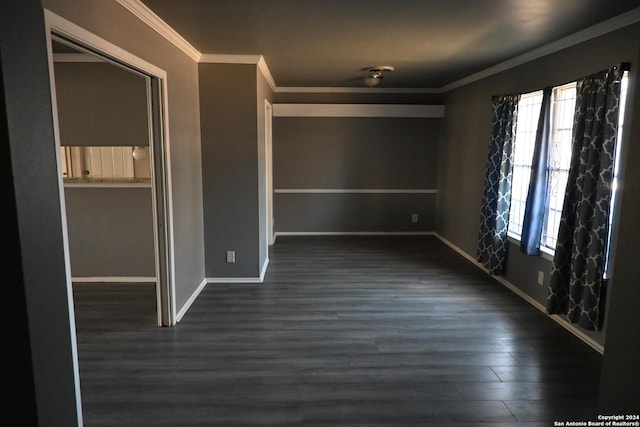 spare room featuring dark hardwood / wood-style flooring and ornamental molding