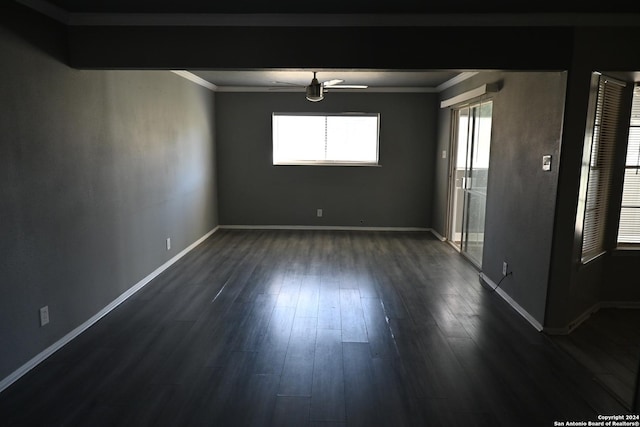 unfurnished room featuring ornamental molding, ceiling fan, and dark wood-type flooring