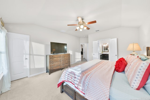 carpeted bedroom featuring connected bathroom, vaulted ceiling, multiple windows, and ceiling fan