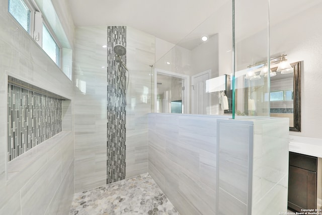 bathroom featuring vanity and a tile shower