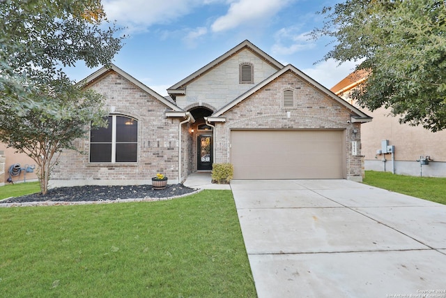 view of front of property featuring a garage and a front yard