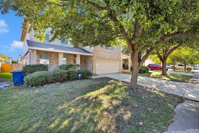 view of front of property featuring a front lawn and a garage