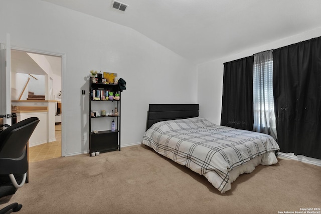 carpeted bedroom with vaulted ceiling