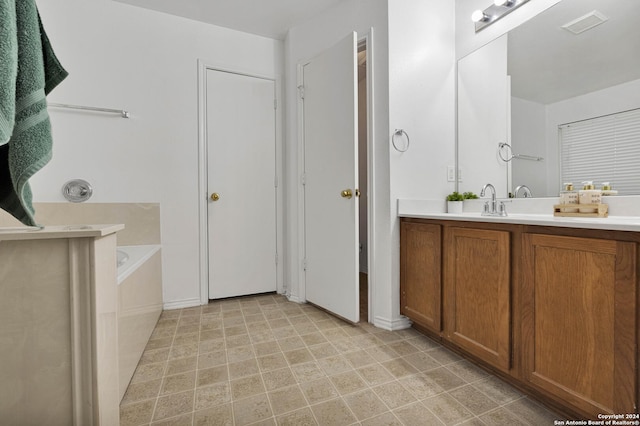 bathroom featuring a washtub and vanity