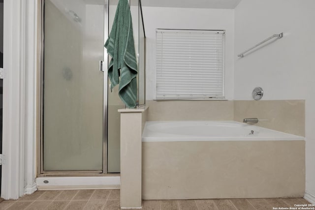 bathroom featuring separate shower and tub