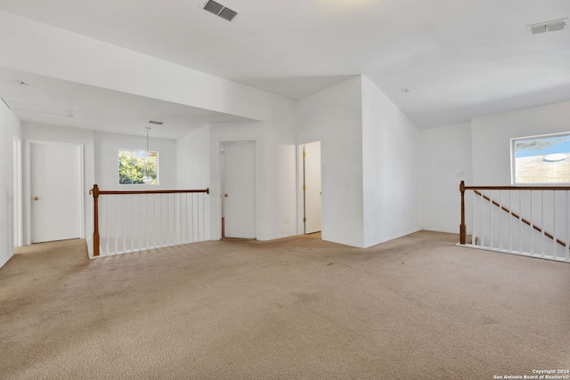 carpeted empty room featuring a healthy amount of sunlight