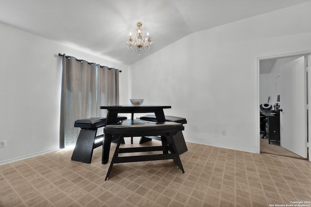 dining area featuring vaulted ceiling and a notable chandelier