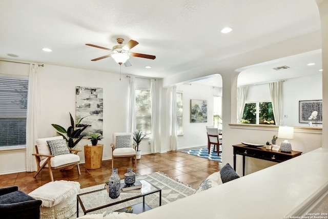 living room with tile patterned floors and ceiling fan