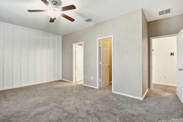 unfurnished bedroom with ceiling fan and light carpet