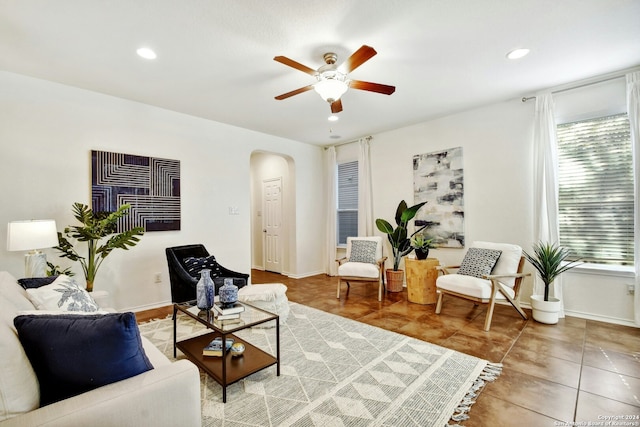 living room featuring tile patterned flooring and ceiling fan