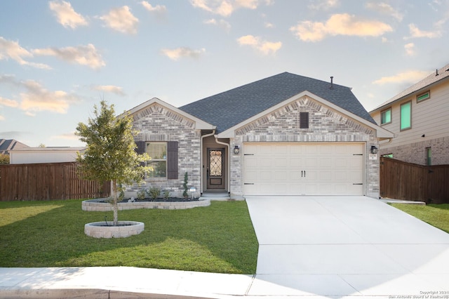 view of front of property with a garage and a front yard