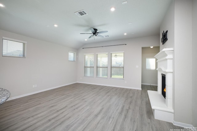 unfurnished living room featuring lofted ceiling, ceiling fan, and light wood-type flooring