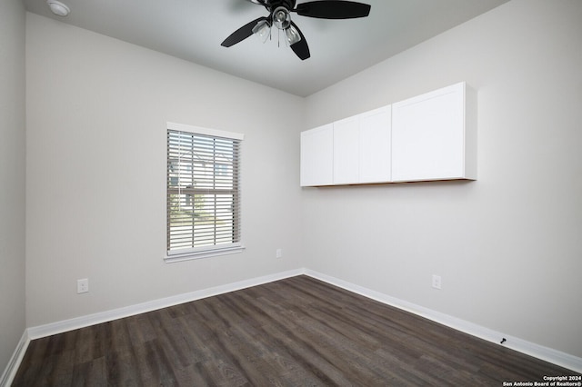 unfurnished room featuring dark hardwood / wood-style floors and ceiling fan