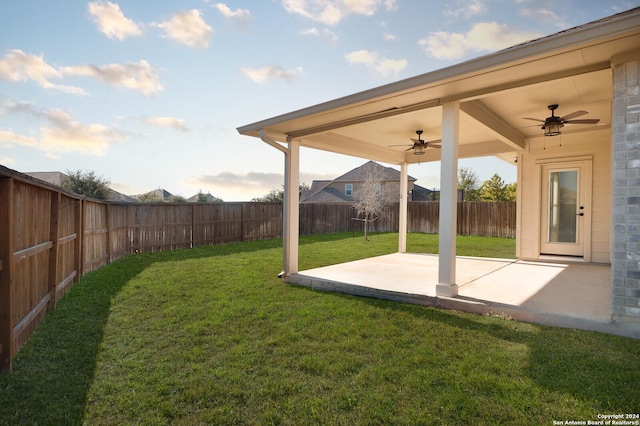 view of yard featuring ceiling fan and a patio