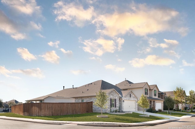 view of front facade with a front yard and a garage