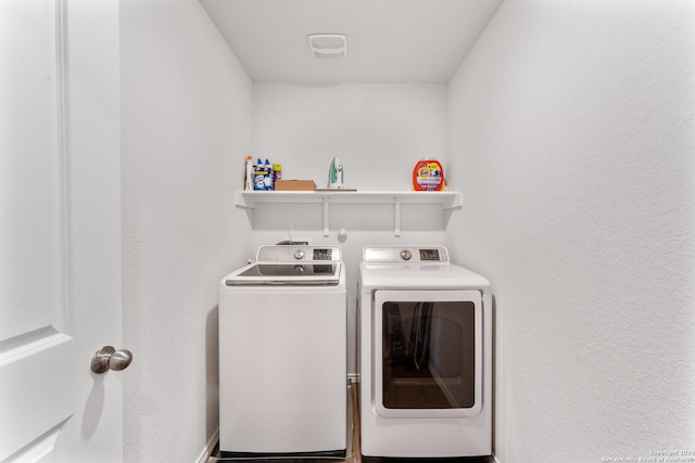 clothes washing area featuring washer and dryer