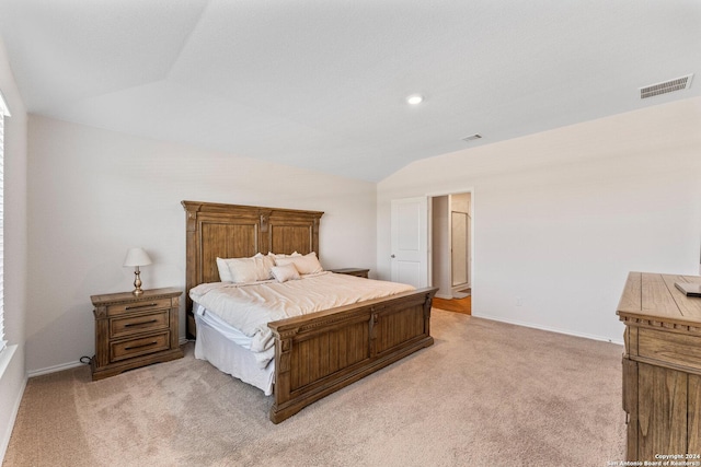 carpeted bedroom featuring lofted ceiling