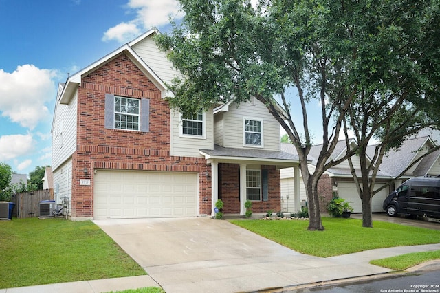 view of front of house featuring cooling unit, a garage, and a front yard