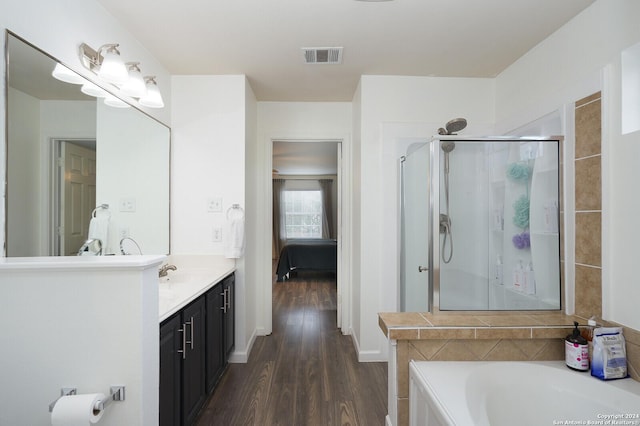 bathroom featuring vanity, plus walk in shower, and hardwood / wood-style flooring