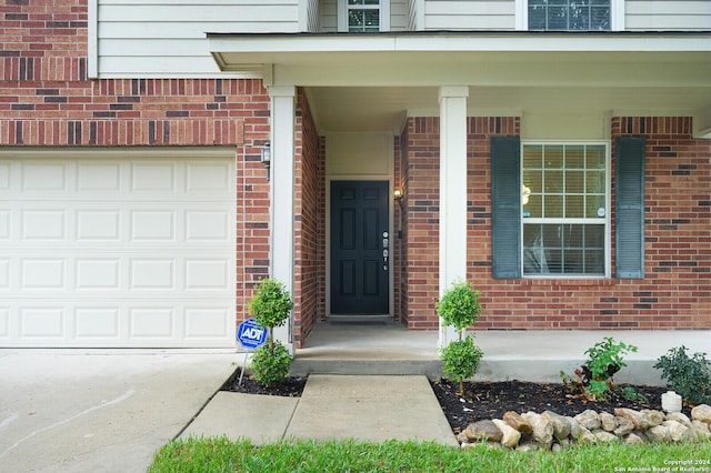 view of exterior entry featuring a garage