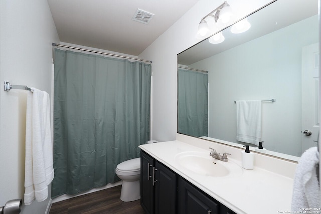 bathroom featuring wood-type flooring, vanity, and toilet