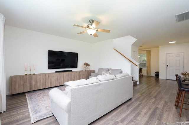 living room featuring dark hardwood / wood-style floors and ceiling fan