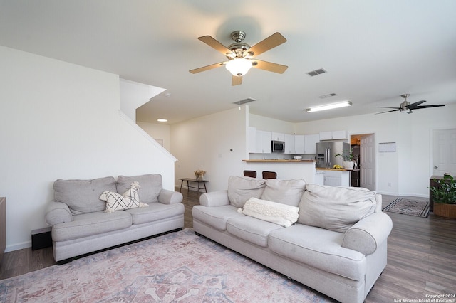 living room with light hardwood / wood-style floors and ceiling fan