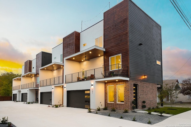 view of front of house featuring a garage and a balcony