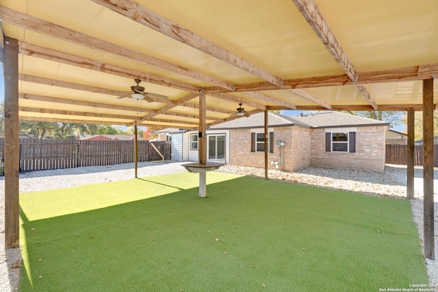 view of patio with ceiling fan and an outbuilding