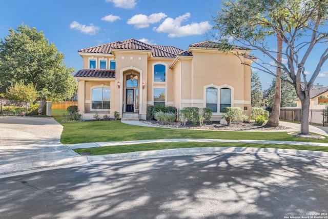 mediterranean / spanish-style house with a front lawn