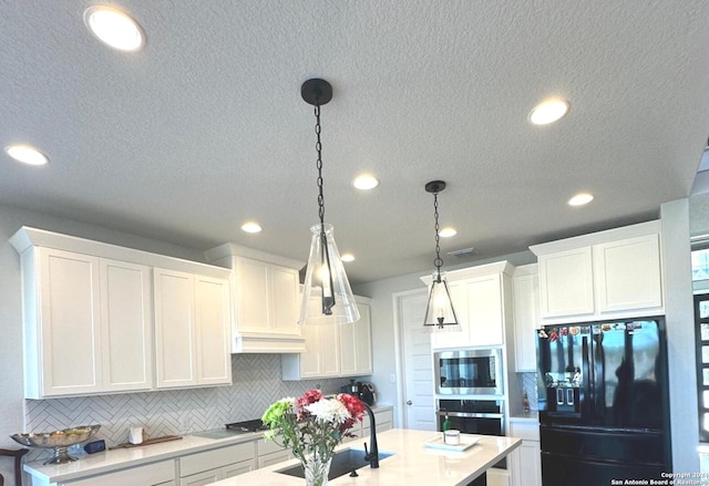 kitchen with white cabinets, decorative light fixtures, decorative backsplash, and appliances with stainless steel finishes