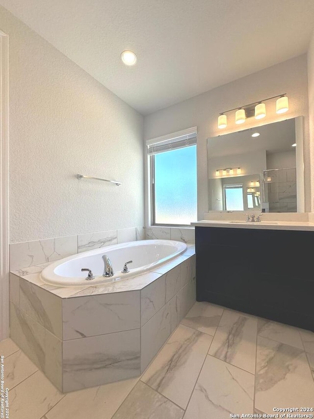 bathroom featuring separate shower and tub and vanity