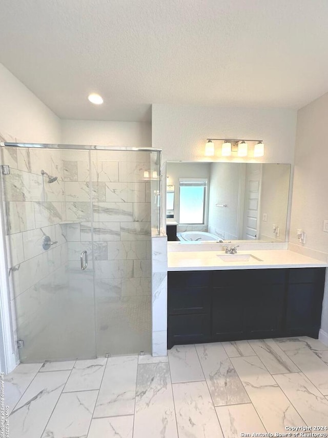 bathroom featuring vanity, plus walk in shower, and a textured ceiling