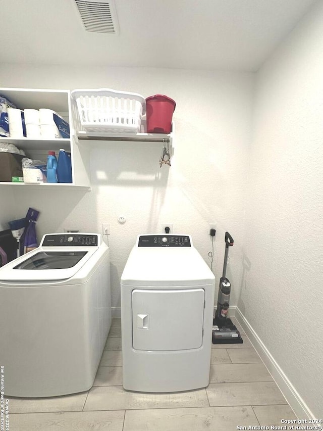 clothes washing area featuring washer and dryer