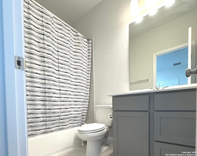 full bathroom featuring tile patterned flooring, vanity, toilet, and shower / tub combo with curtain