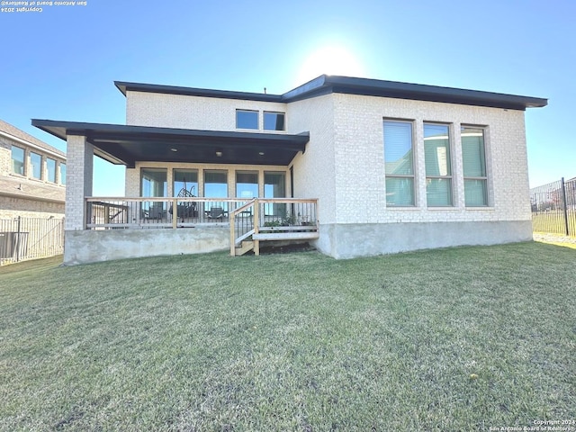 back of property with covered porch and a yard