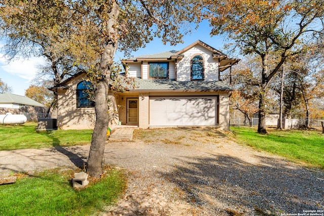 view of front property with central AC unit, a garage, and a front yard